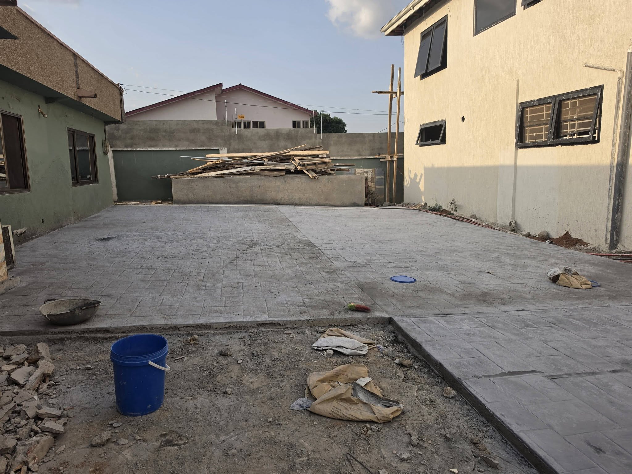 Precision stamped concrete driveway and compound civil works with retaining wall construction